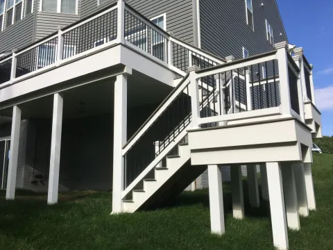 Elevated deck with white columns and black aluminum balusters built by PRG Home Improvement in Maryland