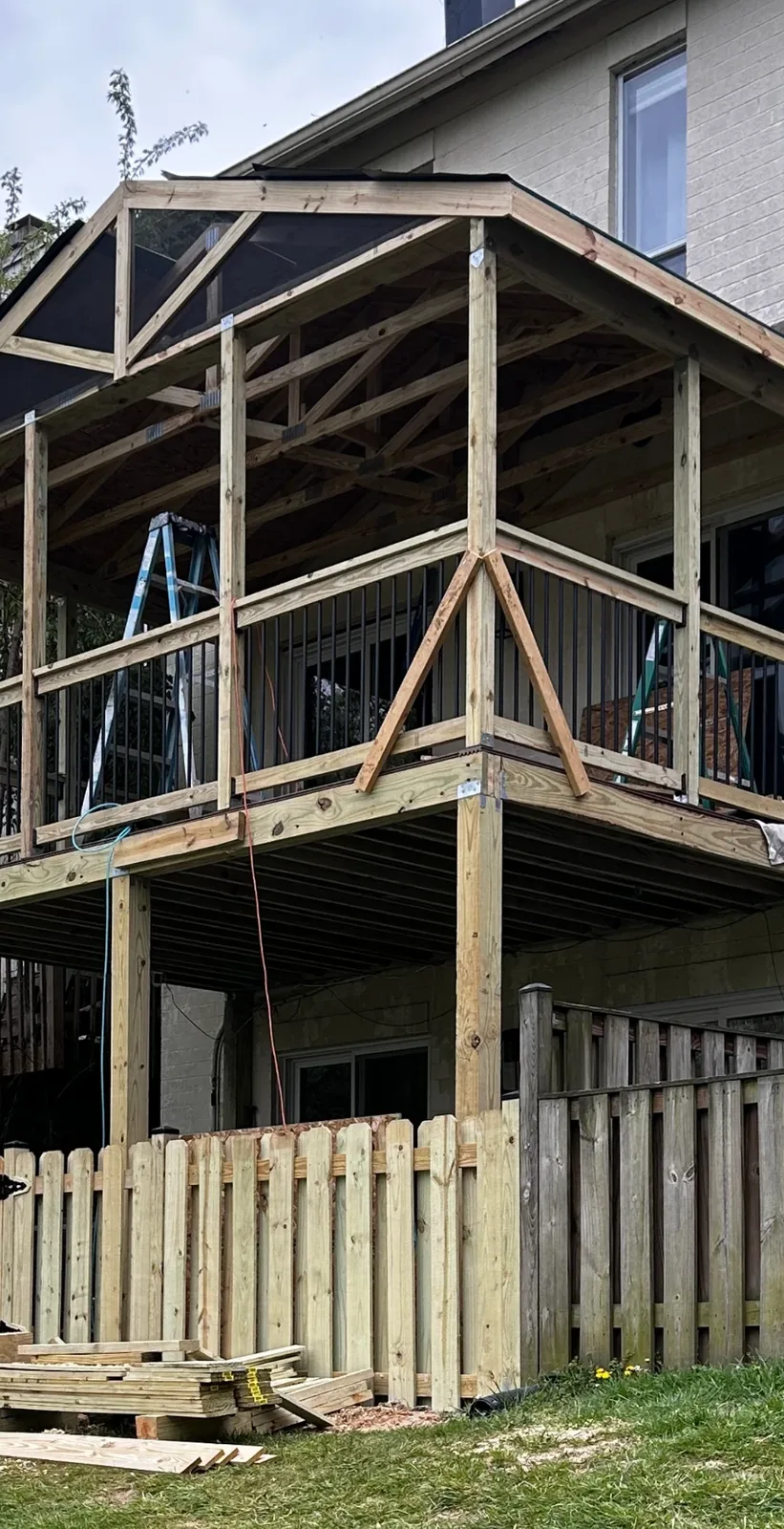 Post-to-beam framing connections with angle bracing on an elevated screened porch build