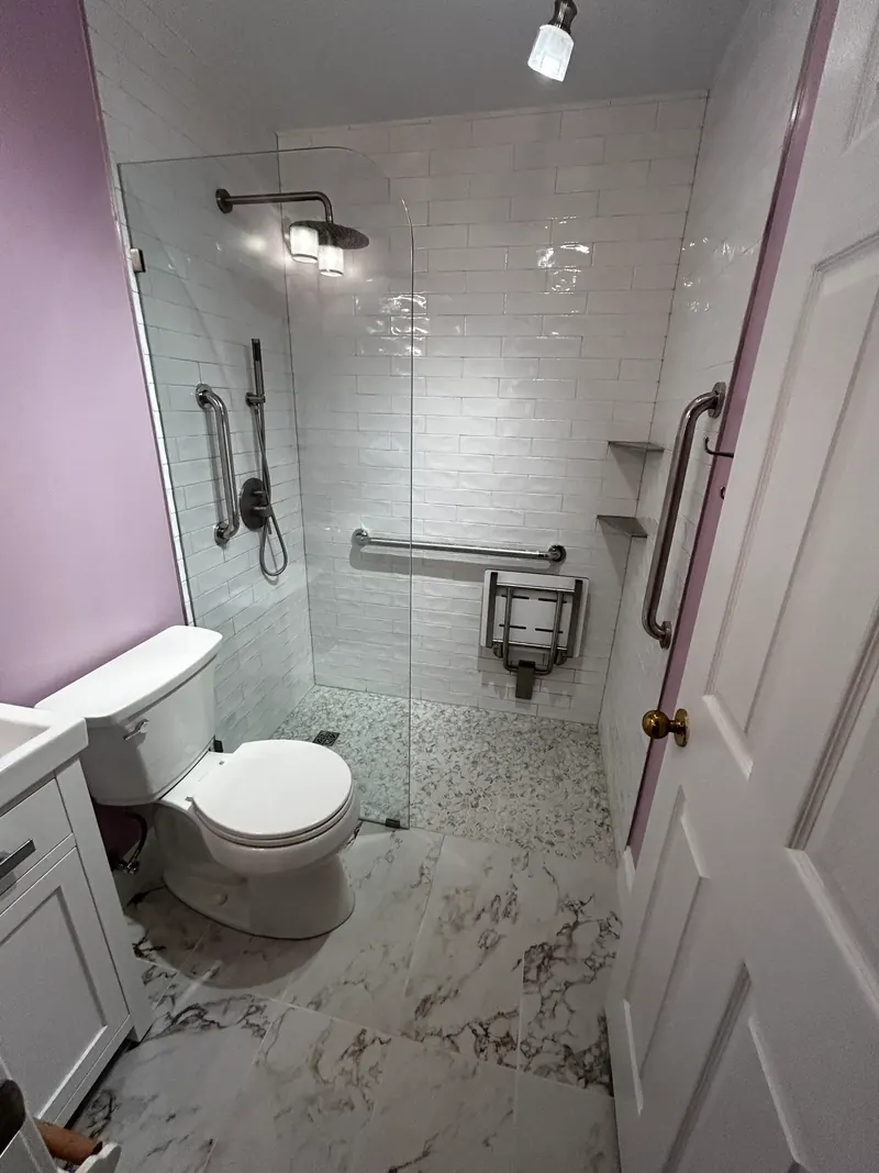 Tub-to-shower conversion with subway tile and glass enclosure in Odenton MD