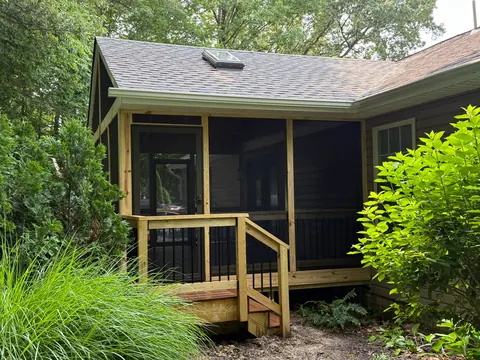 Screened-in porch addition with wood framing and steps built by PRG Home Improvement in Maryland