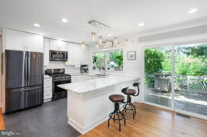 Modern farmhouse kitchen with white shaker cabinets and quartz island in Odenton MD